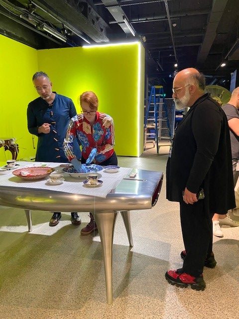 Rokni Haerizadeh, Julia Mackay and Ramin Haerizedeh in the gallery space testing out the placement of the ceramics on the Marc Newson 'Event Horizon' table. A piece of celair is being used as a barrier bwtween the table and the ceramics while the placement is finalised.